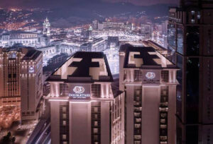 Exterior view of DoubleTree by Hilton Jabal Omar Makkah illuminated at night near the Haram